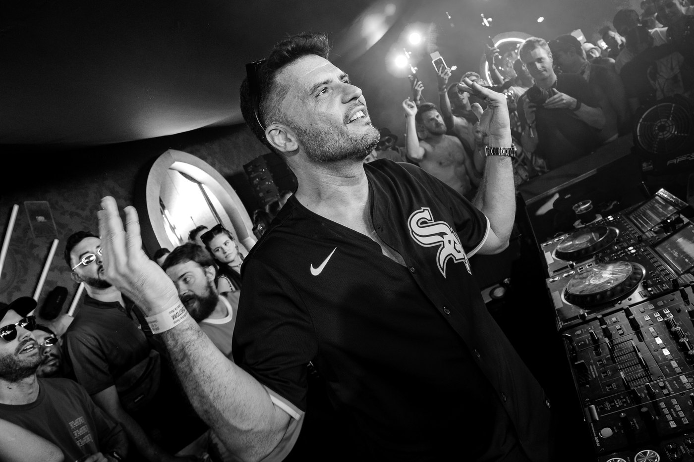 Jose De Mara, house and tech house DJ, playing live in front of the crowd, black and white photograph · PLAYNOW