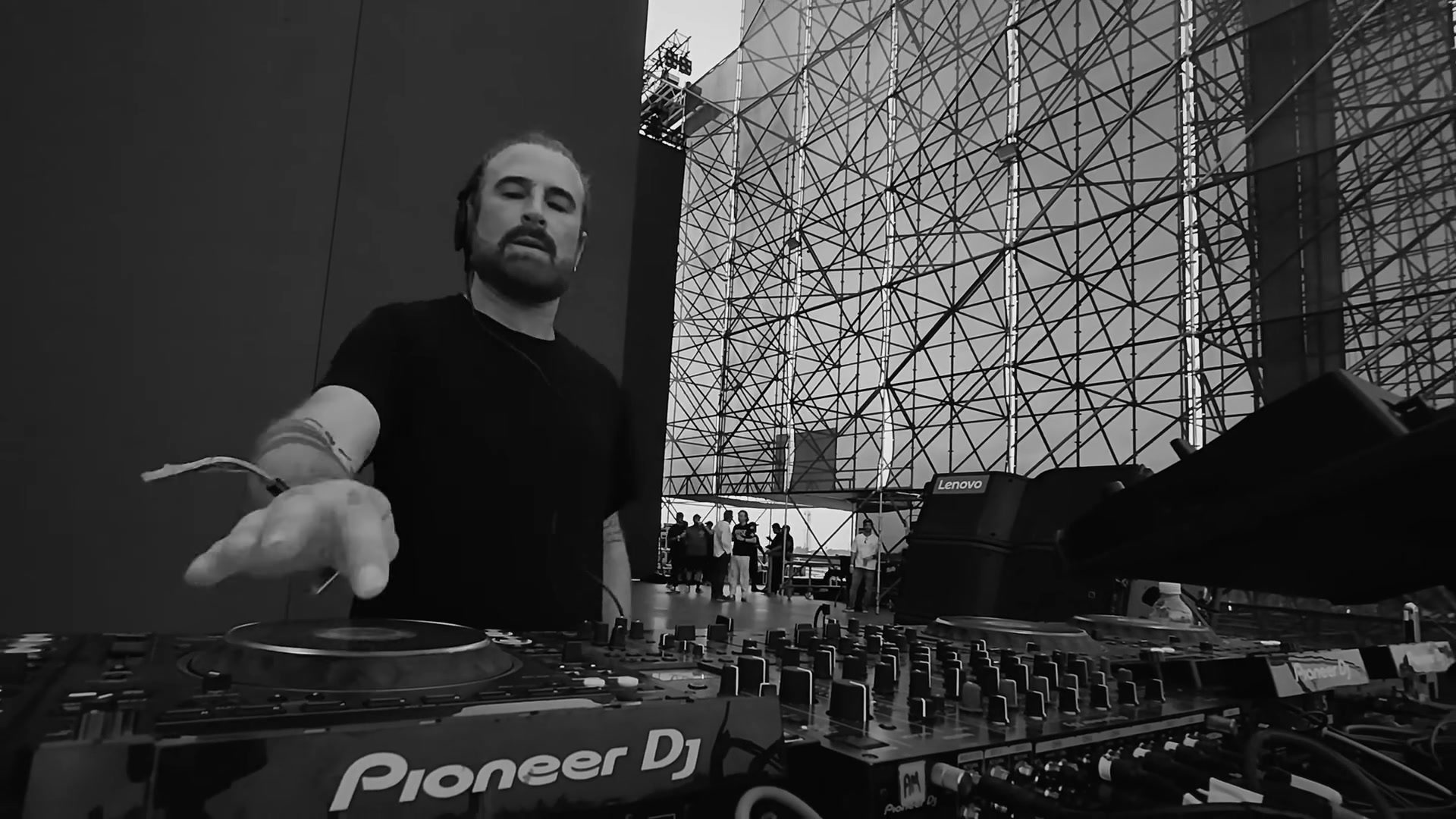 JP Candela playing in the A Summer Story booth, black and white · PLAYNOW